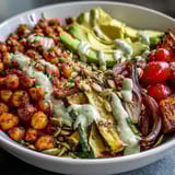 A close-up of the vibrant Chickpea Power Bowl highlights crispy chickpeas, fluffy quinoa, and colorful roasted veggies, ready to enjoy.