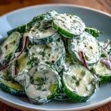 Refreshing dill cucumber salad with red onions and creamy dressing, a light side for barbecues and potlucks.
