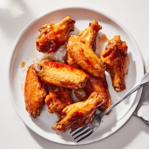 A platter of glazed Honey BBQ Chicken Wings served with crisp celery and blue cheese dip.