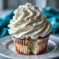 Communion cupcakes with white fondant cross toppers, beautifully frosted with creamy buttercream and delicate fondant crosses.  